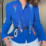 Cardigan con dibujos bordados